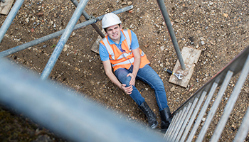 Construction-worker-sitting-on-the-ground-injured.jpg