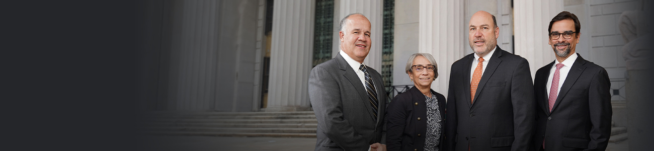 Group photo of Clark, Gagliardi & Miller, P.C. standing in front of a building.