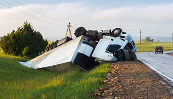 Overturned truck on the side of a road